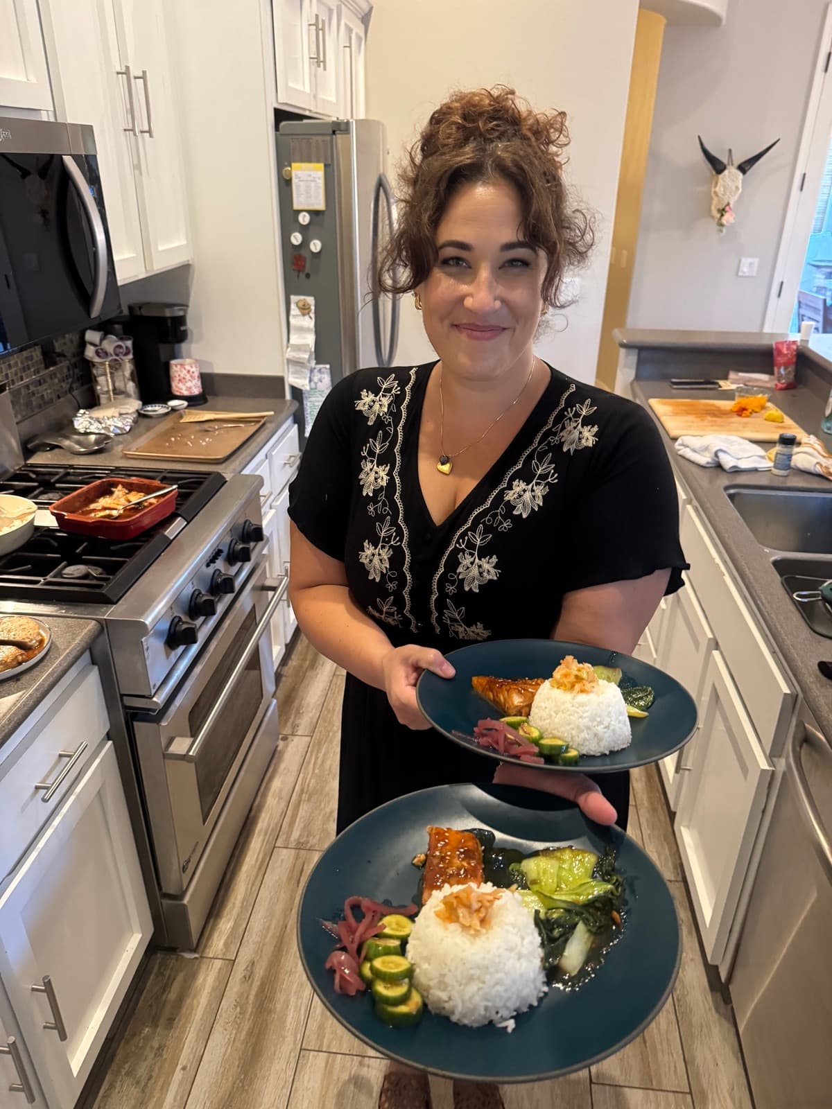 Chef Jenna plating teriyaki salmon dinners in the kitchen