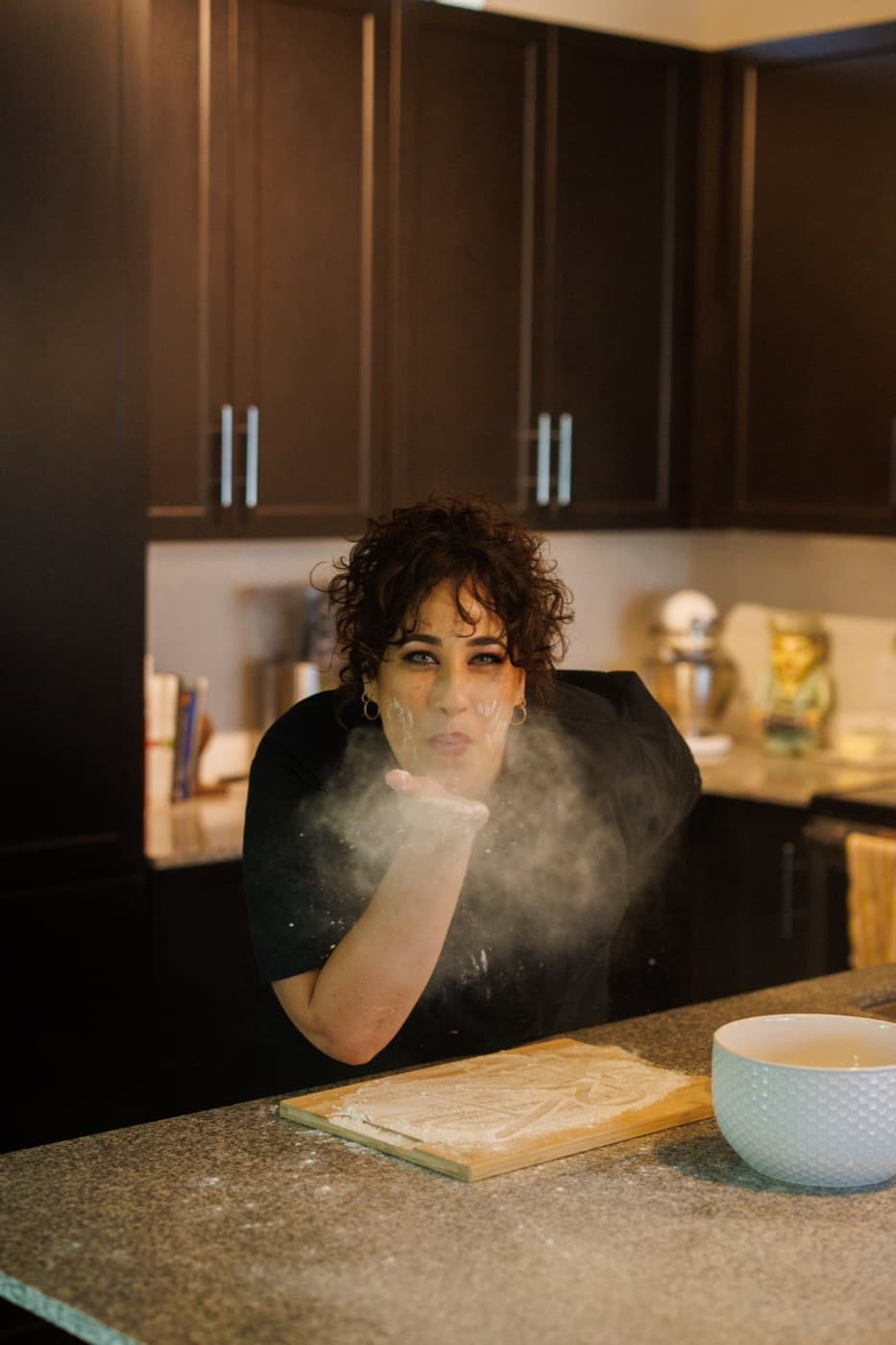 Chef Jenna blowing flour from her hand